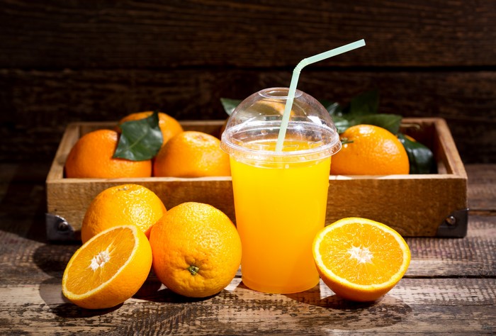 Oranges and orange juice in a cup