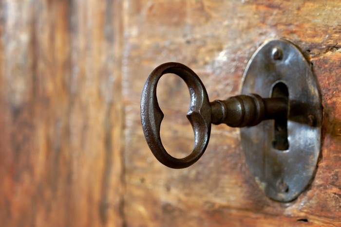 Old key in a wooden door lock