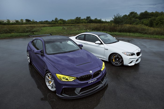 Two BMWs parked on a wet road