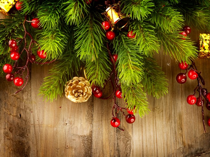 Christmas Branches with Berries and Ornaments on Wood