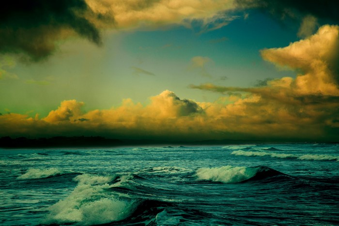 Ocean waves under dramatic clouds
