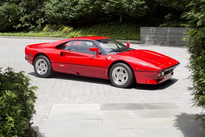 Red Ferrari GTO parked on a paved driveway