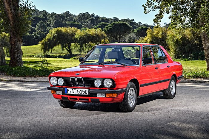 Red 1983-87 BMW 524td parked on asphalt