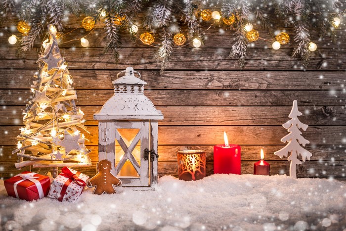 Christmas scene with gifts, lantern, candles, and tree