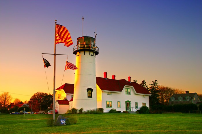 Chatham Harbor Lighthouse with American Flags at Sunset