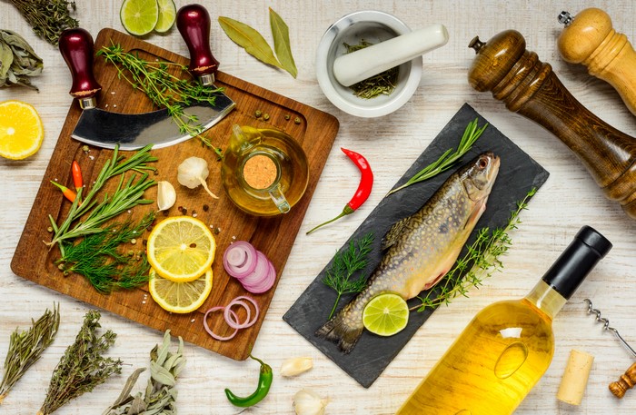 Fish and Ingredients on Cutting Board with Wine