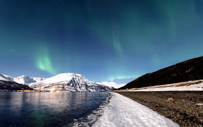 Aurora Borealis over Snow-Capped Mountains and a Fjord