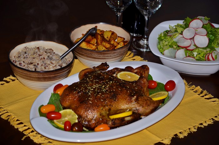 Roast chicken with rice, potatoes, and salad