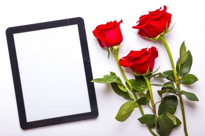 Tablet and Red Roses on White Background