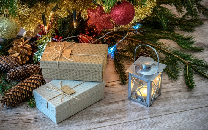 Christmas gifts and lantern under a tree