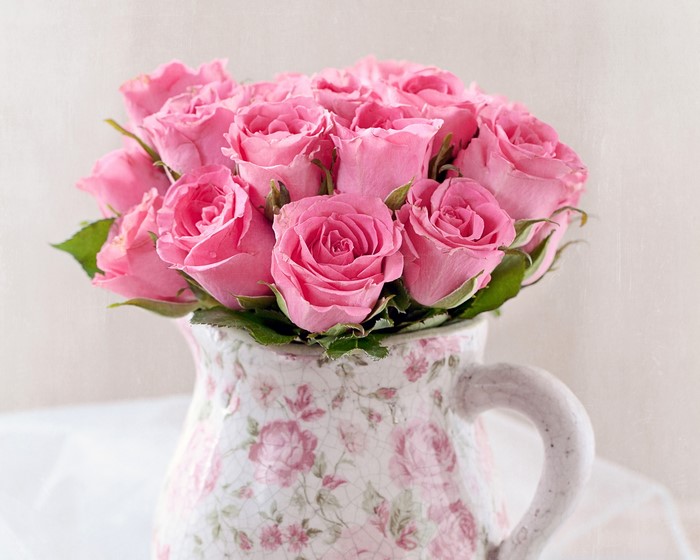 Pink roses in a floral pitcher