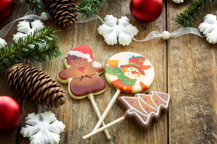 Christmas sweets on wooden planks with pine cones and snowflakes