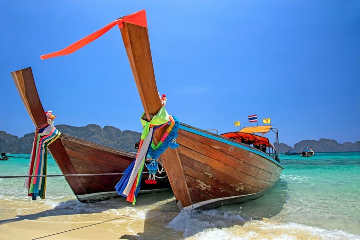 Two wooden boats on a tropical beach
