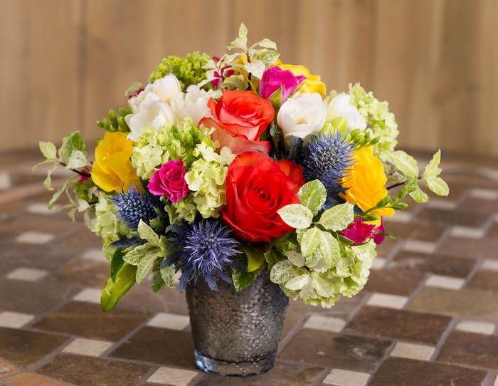 Colorful floral arrangement in a textured vase