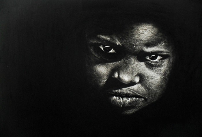Close-up of a young Black person's face in shadow
