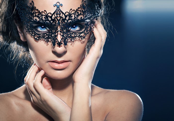 Woman wearing a black lace masquerade mask