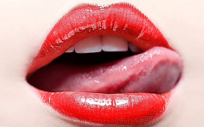 Close-up of red lips with tongue and teeth