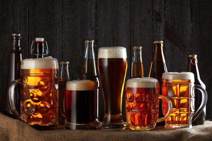 Beer in mugs and bottles on a dark background