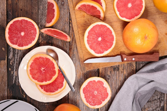 Grapefruit slices on a plate with a knife