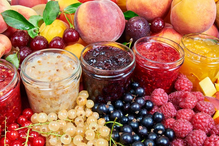 Jars of Fruit Jam with Fresh Berries and Peaches
