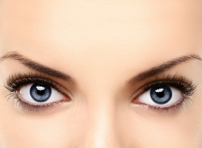 Close-up of a woman's blue eyes and eyelashes