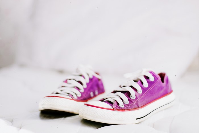 Purple Converse sneakers with white laces