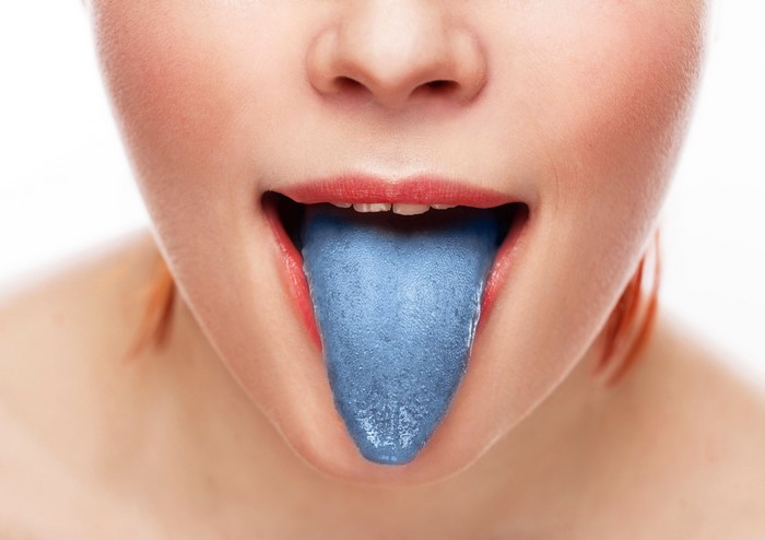 Woman with blue tongue sticking out