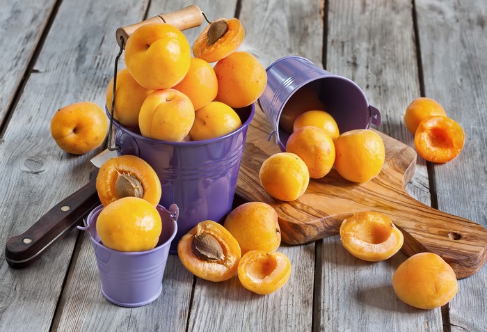 Apricots in buckets on wood planks