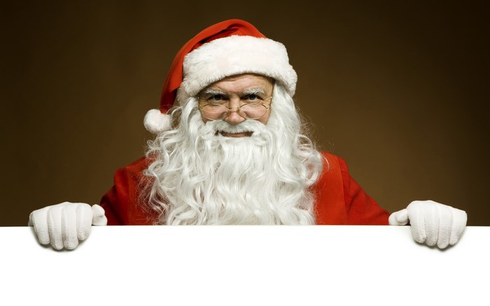 Santa Claus holding a white board