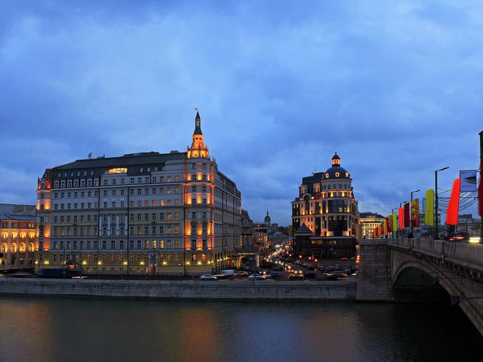 Moscow riverfront buildings and bridge at dusk