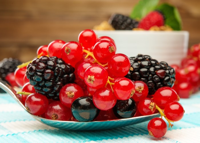 4K Close-up of Blackberries and Red Currants on a Spoon