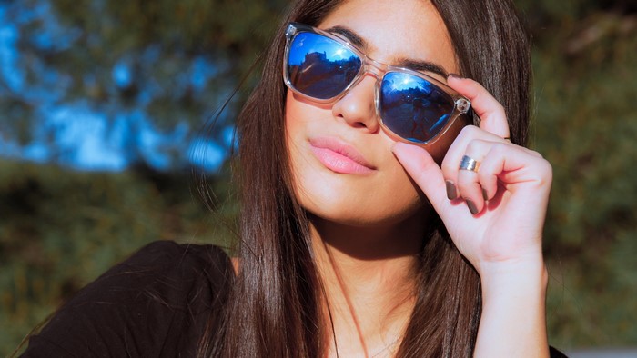 Woman wearing sunglasses with reflection