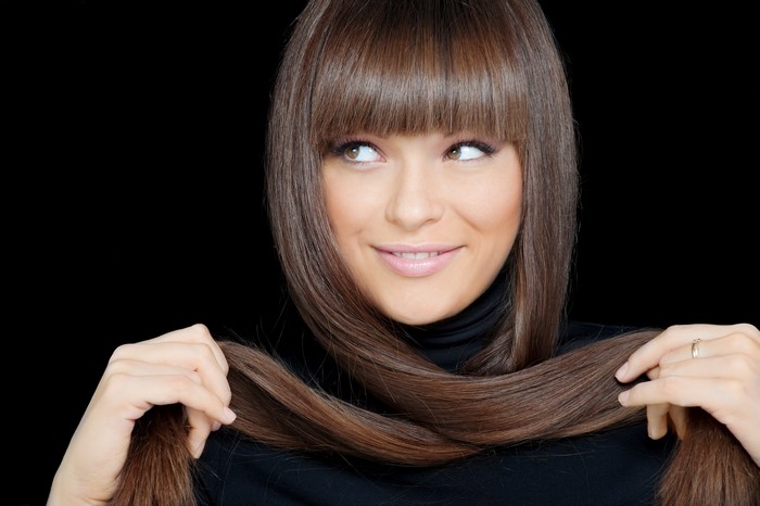 Woman with long brown hair and bangs