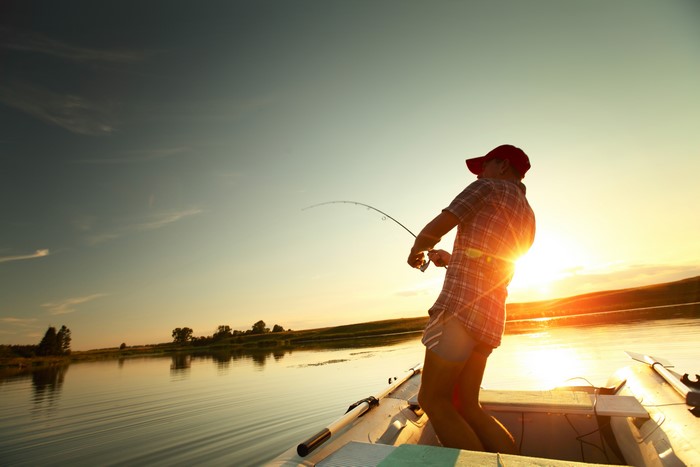 Fishing from a boat at sunset