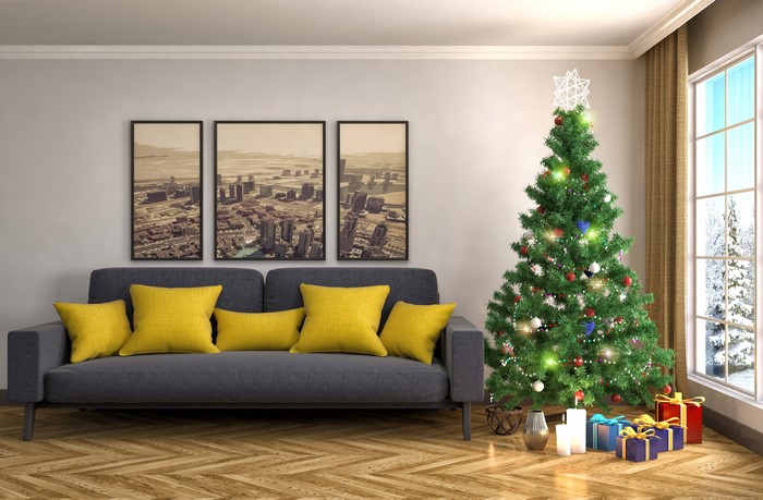 Christmas tree with gifts and sofa in a living room