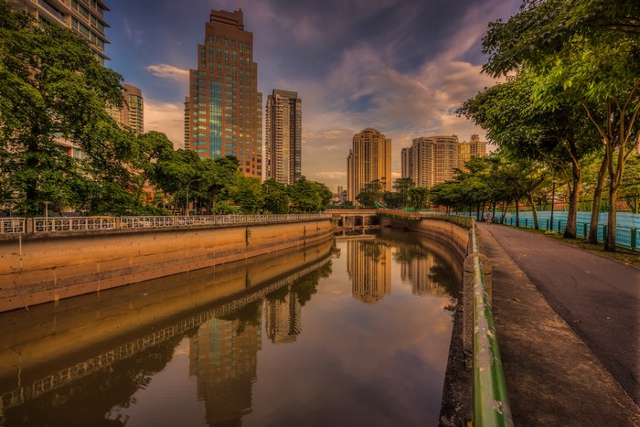Canal with skyscrapers and trees in Singapore