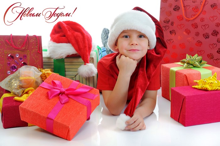 Boy in Santa hat with Christmas gifts