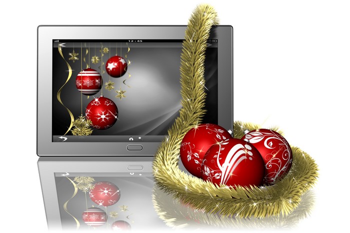 Tablet with Christmas ornaments and tinsel