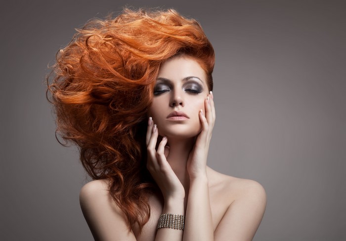 Redhead woman with dramatic hairstyle and makeup