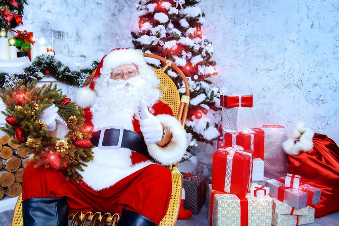 Santa Claus with Christmas tree and gifts