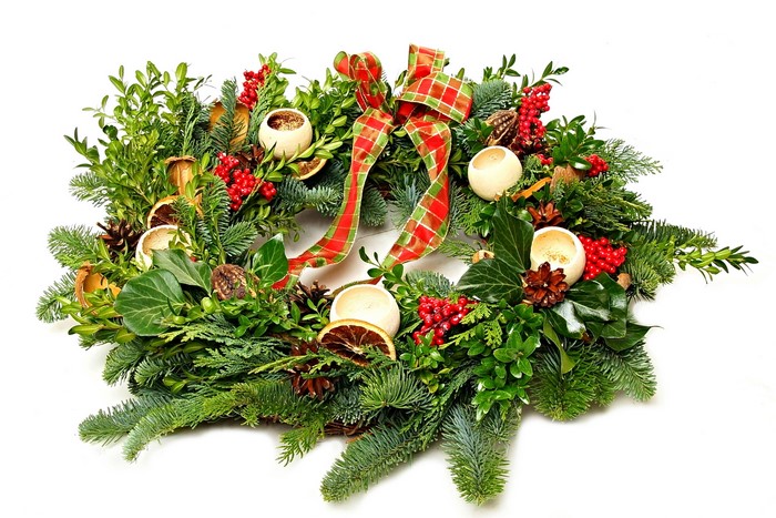 Christmas wreath with berries, pine cones, and ribbon