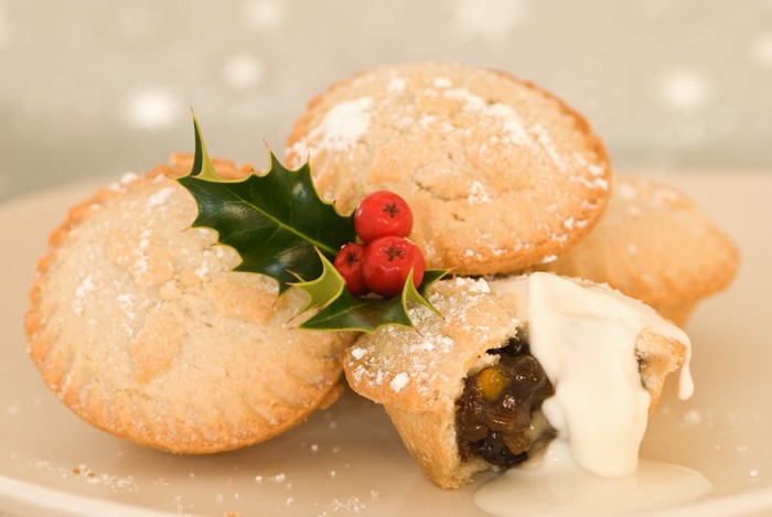 Christmas mince pies with holly and cream