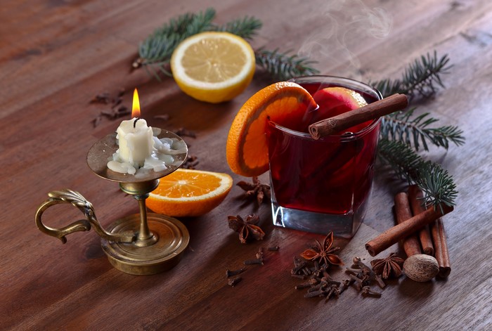 Mulled wine with orange, cinnamon, and candle