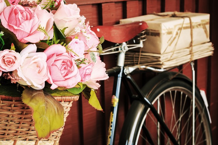 Pink Roses in Wicker Basket on Bicycle with Packages