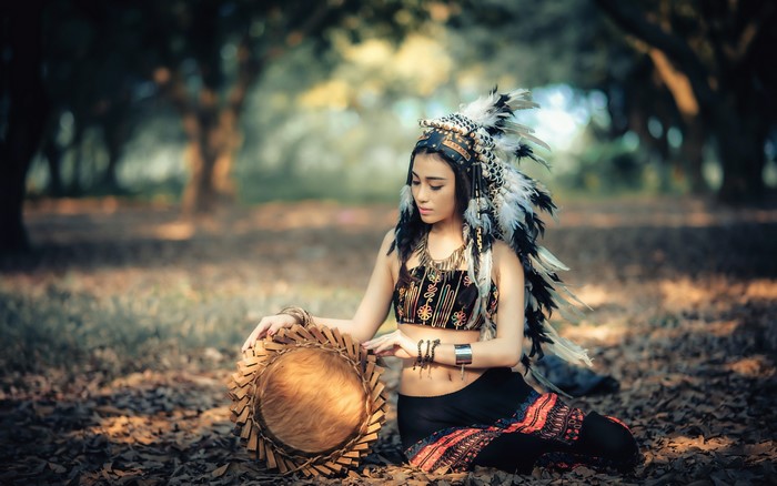 Woman in Native American Headdress with Drum