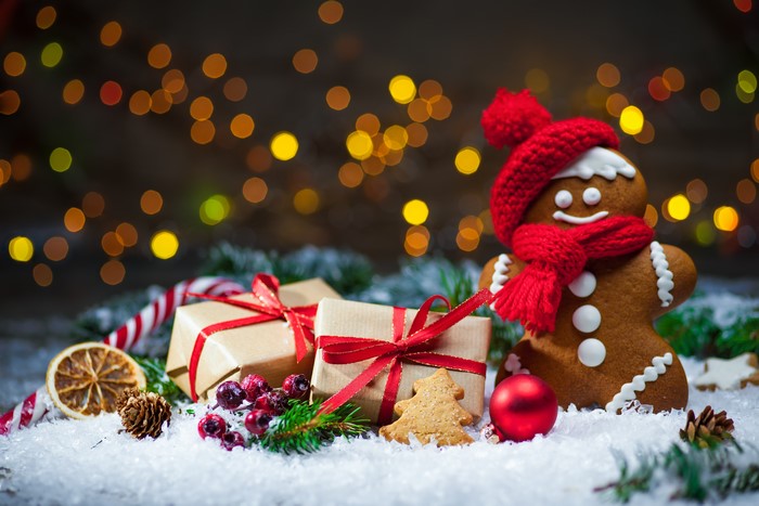 Christmas gingerbread man with gifts and bokeh lights