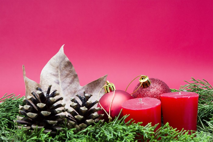 Christmas decoration with pine cones, candles, and ornaments
