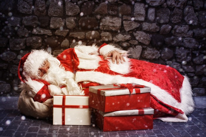 Santa Claus sleeping with gifts