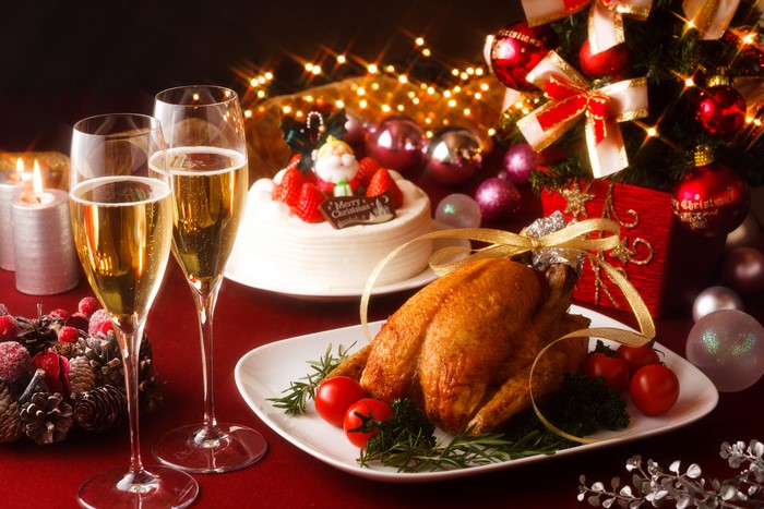 Christmas dinner with roast chicken, cake, and champagne