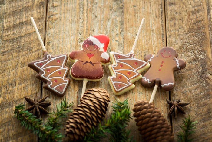Christmas cookies on sticks with pine cones and fir branches